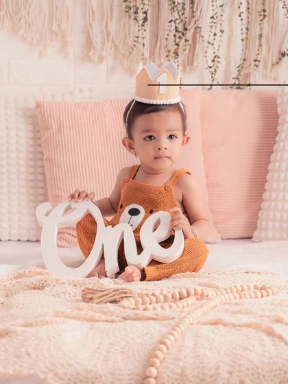 A close-up of this little king on his first birthday. The soft textures and warm tones of this bohemian setup make for a very cozy and sweet portrait.
