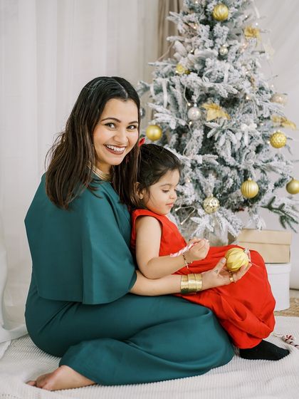 A mother and daughter sitting by the Christmas tree. A quiet, loving moment amidst the holiday excitement.