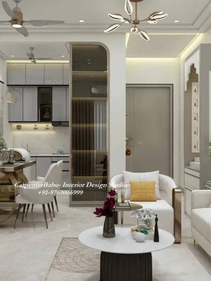 An open-plan living, dining, and kitchen area. A glass partition with gold accents separates the kitchen, adding a touch of glamour while maintaining an open feel.