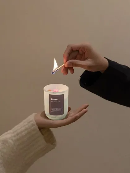 A moment of peace. One of our hand-poured jar candles being lit, a simple ritual to bring calm and fragrance into your day.