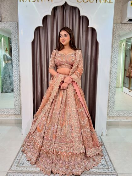 A beautiful peach-rust lehenga with intricate hand embroidery. This is a perfect choice for a pastel-themed wedding, making you stand out.