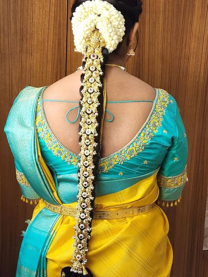 A back view of a bride wearing a stunning pearl and Kemp stone 'Jade Bangara'. This hair accessory adds so much grace and detail to the overall look.