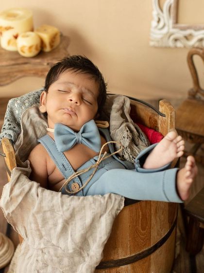 This charming little gentleman is Sundaying in style with his tiny bow tie. The rustic bucket and warm tones create a cozy and classic portrait.