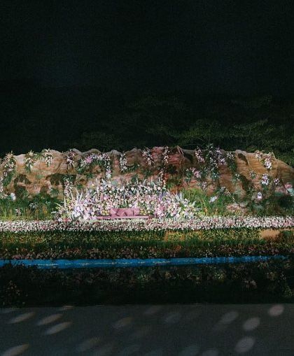 The full view of the reception stage from a distance, emphasizing its magnificent scale and the way it transforms the entire venue into a different world.