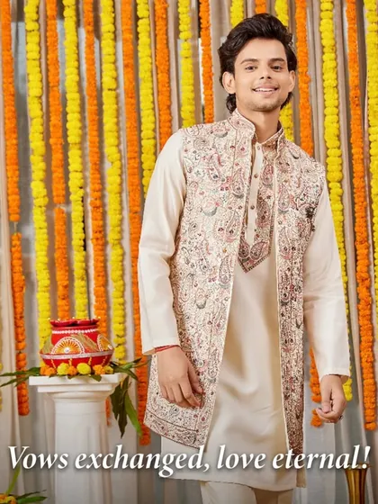 Vows exchanged, love eternal. This groom's friend looks sharp and celebratory in a beige Indo-Western set with a beautifully embroidered jacket, perfect for witnessing a special moment.