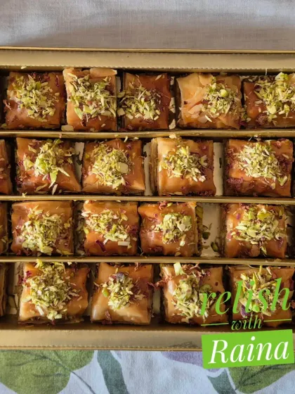My homemade eggless Baklava, neatly packed and ready for you. Each piece has layers of flaky phyllo, a filling of almonds and pistachios, and is sweetened with a special syrup of jaggery and honey.
