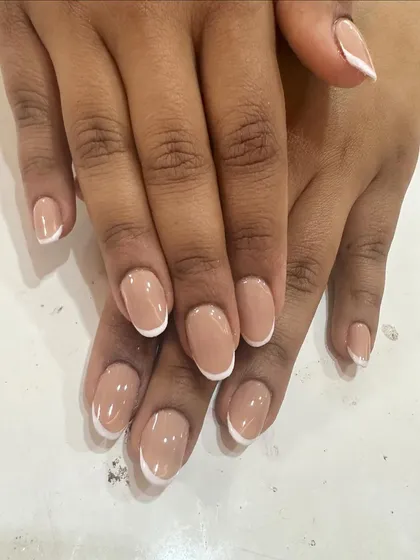 Simplicity at its best. This is a perfect, classic French manicure on short, rounded nails, proving that this timeless look is beautiful at any length.