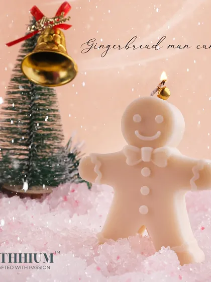 The Gingerbread Man candle, lit and glowing, ready to add warmth and cheer to your Christmas decor.