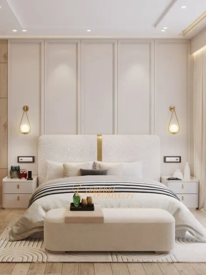 A serene master bedroom defined by clean lines and warm textures. The custom upholstered headboard and soft, ambient lighting from the teardrop sconces create a tranquil retreat from the everyday.
