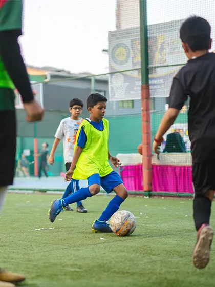 Teamwork and strategy in action during a junior football drill. Players learn to move, pass, and think as a unit, developing their game sense in a competitive but supportive environment.