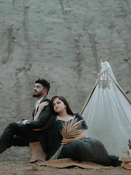 A moody and artistic pre-wedding portrait of a couple at a quarry. The dramatic landscape and their pose create a cinematic feel.