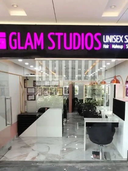 Look for our signature pink sign. This is the entrance to our unisex salon, where we offer a full range of services for hair, makeup, skin, and nails. We are ready to welcome you for your next transformation.