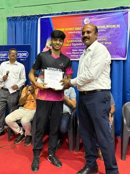K J Akash receiving his award for winning the Men's Singles title at the Mysore state ranking tournament.