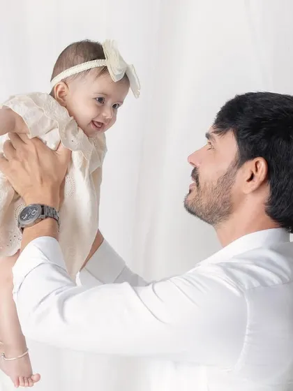 A father's love, lifting his daughter up. The joy and trust in her eyes as she looks at her dad is beautiful.