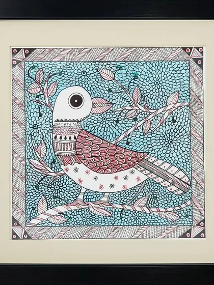 This Madhubani painting by Lakshit Mukhiya features a bird perched on a branch against a textured blue background. The detailed patterns on the bird and in the background create a rich and cohesive artwork.
