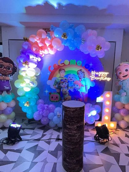 Another view of the Cocomelon first birthday party, showing the character cutouts and the full backdrop that brings the popular show to life.