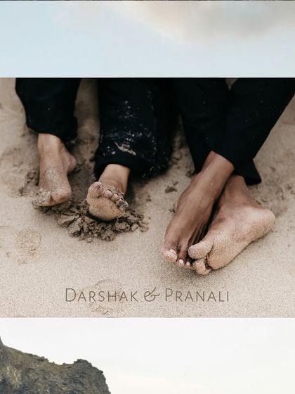 A simple yet intimate shot focusing on the couple's sandy feet, symbolizing their journey together.