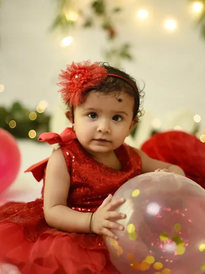 Before the cake smash, we capture some clean portraits. This little girl in her sparkly red dress looks so sweet and innocent before the messy fun begins.