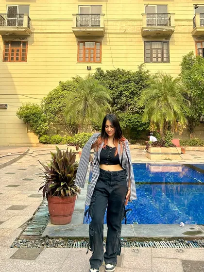 A happy, smiling shot in the poolside outfit. This shows that style can be both cool and approachable.