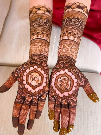 An example of how I personalize bridal mehandi. This design features the couple's initials, "NP," elegantly placed within a floral mandala, making the henna truly unique to their story.