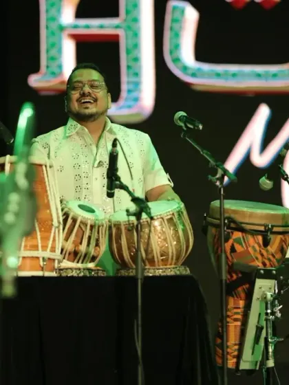 Our percussionist smiling, feeling the rhythm at a Rotary Club event in Jodhpur. We love performing for causes that unite people.