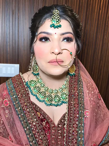 This close-up shows the delicate nath and the details of her heavy kundan necklace.