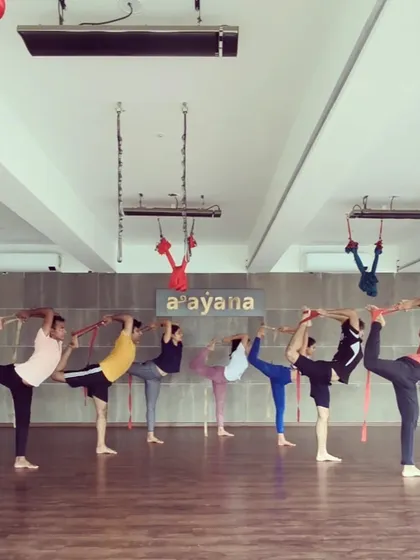 "Teach, Love, Inspire." Our community practices Natarajasana together, each at their own level, supporting each other's journey.
