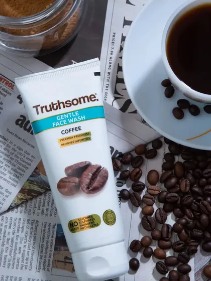 A lifestyle product shot for a coffee-based face wash. I used a newspaper, coffee beans, and a cup of coffee as props to build a narrative around the product's main ingredient.