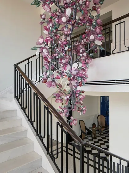 This custom 13-foot cherry blossom chandelier is the magical centerpiece of an 11,000 sq ft South Bombay home. It cascades down the staircase, transforming a functional area into a breathtaking design statement. It’s these one-of-a-kind details that bring a client's unique story into their home.