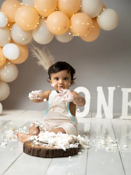 A sweet, messy smile that melts your heart. This is the essence of a cakesmash, capturing the fun and freedom of being one.