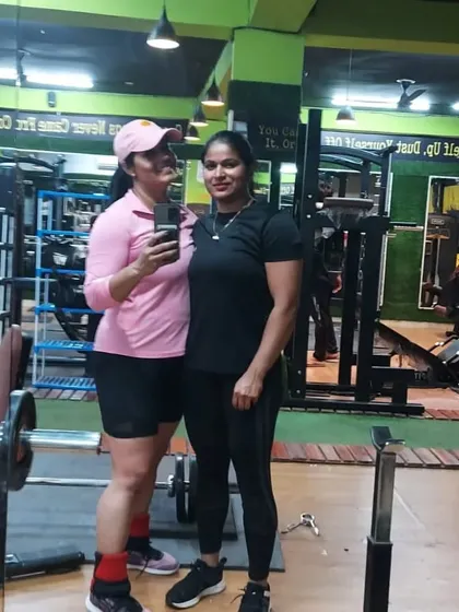 With a friend at the gym. Having a training partner can make all the difference on days when motivation is low.
