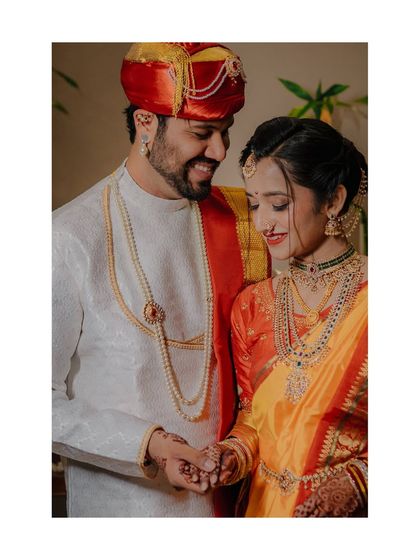 A beautifully framed portrait of Vaibhav and Tanvi, their yellow and red outfits creating a warm and traditional look.