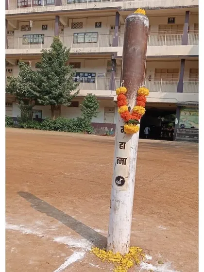 The Kho-Kho pole, decorated with flowers during our Dussehra puja. We treat every part of our sport with reverence.