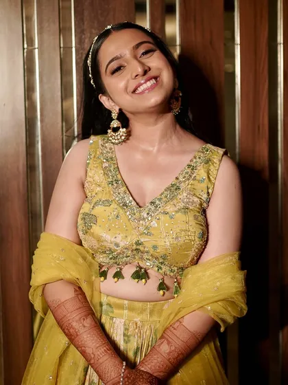 A bright, happy smile from the Haldi ceremony. The makeup is fresh and luminous, perfect for celebrating with family and friends.