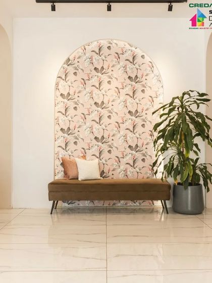 The waiting area at 'Frumos' salon, featuring a beautiful floral wallpaper set within an arch. This creates an elegant focal point and a comfortable space for clients.