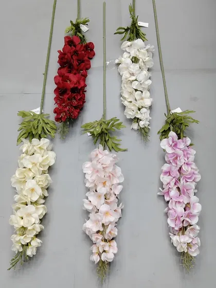 A selection of artificial delphinium or larkspur flower sticks in red, white, cream, and lilac.
