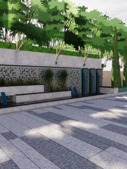 This design features a long, modern water wall with multiple cascades, set against a patterned privacy screen. The feature adds the soothing sound of running water to the space while also serving as a beautiful visual anchor.