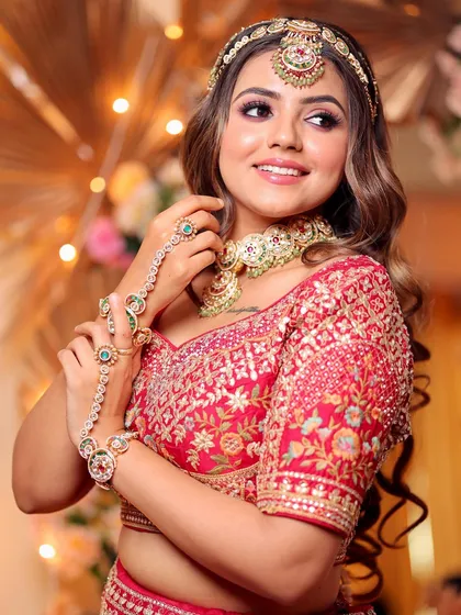 Our version of royalty. This bride looks like a gorgeous goddess with a soft yet glamorous makeup look that enhances her features and complements her red bridal attire perfectly.