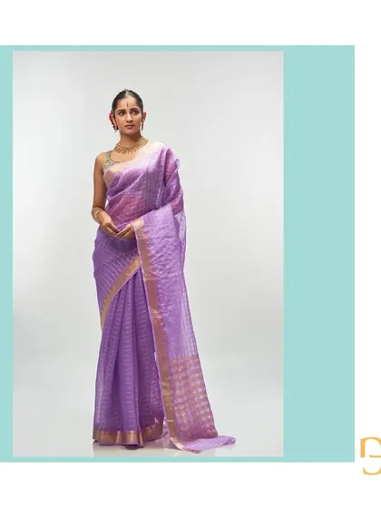 From my Champa collection, this ethereal African Violet silk organza saree is exceptionally lightweight and festive. It is woven with delicate gold zari checks, and the pallu features an interesting play of geometric and floral motifs, creating a dreamy and sophisticated drape.