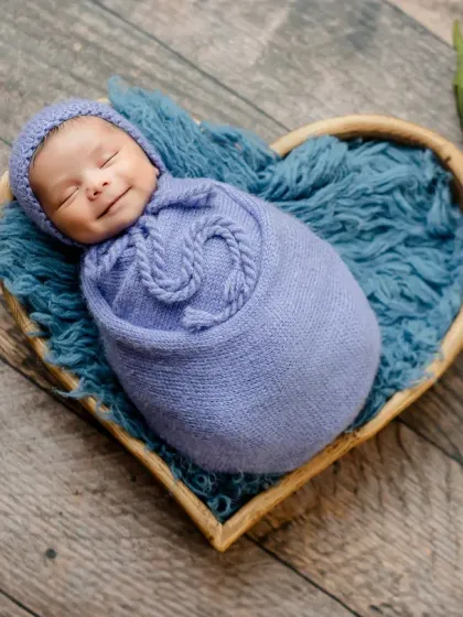 Capturing a newborn's first smile is pure magic. I use careful timing and a comfortable environment in my studio to catch these fleeting, precious expressions.
