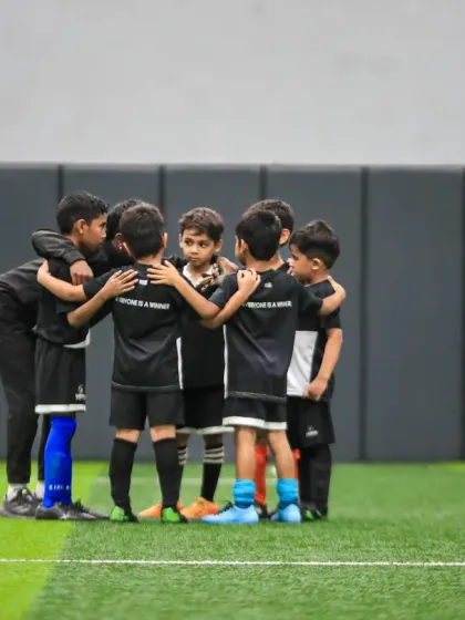 This is where it all begins. A huddle of our junior football players, learning the values of teamwork, strategy, and passion for the game. We focus on developing not just players, but well-rounded individuals.