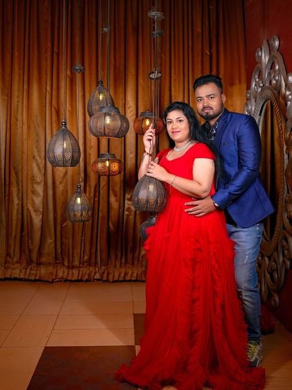 A glamorous maternity photo in our royal room, with the rich colors and unique lamps creating an opulent feel.