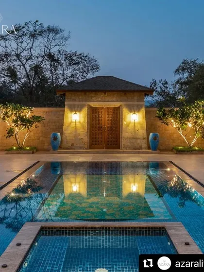The entrance to Casa Azara in Goa is defined by this stunning pool and entryway. Symmetrical planting and dramatic lighting create a formal, elegant approach that reflects in the still water at night.
