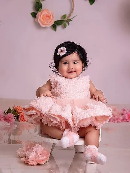 Such a doll! This pretty-in-pink setup is perfect for celebrating a six-month half-birthday milestone.