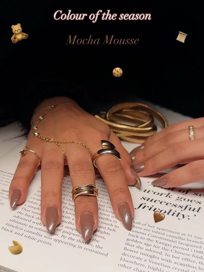The color of the season: Mocha Mousse. This image showcases the rich brown shade, styled with elegant gold jewelry.