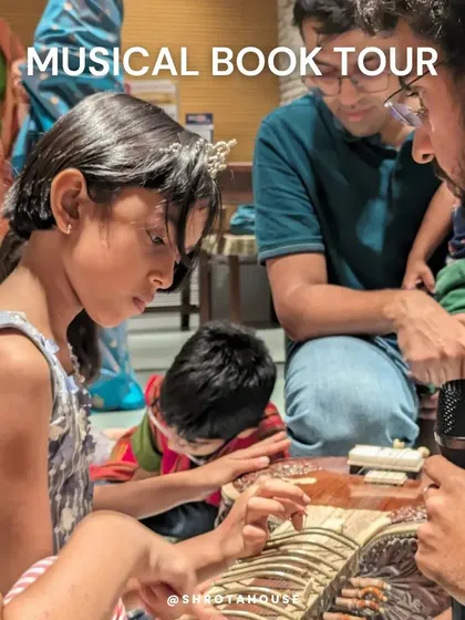 Look at that focus! Our musical book tours are all about hands-on exploration. Here, children get up close with a Santoor, feeling its strings and discovering how it creates its unique sound. We bring the instruments to them.