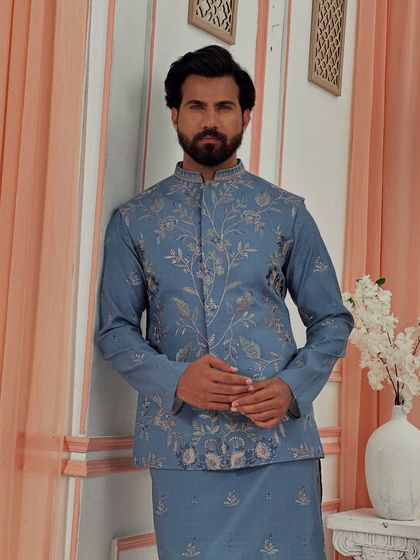 A closer view of the floral embroidery on our blue jacket and kurta set. The fine threadwork and elegant design are crafted to create a look of refined grace for any wedding function.