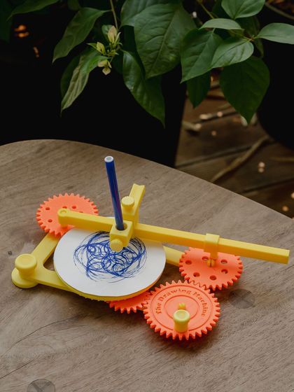 The drawing machine set up outdoors, showing that learning and creating can happen anywhere.