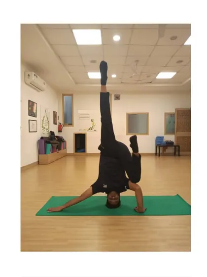 The journey to Sirsasana (Headstand) is a lesson in patience and perspective. This variation, performed in the studio, challenges balance and control. Inversions like this improve circulation and bring a renewed sense of clarity to the mind.
