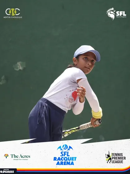A young girl demonstrates a classic backhand slice, a technical shot that shows her developing range of skills during tournament play.